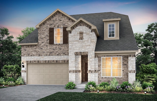 french country home with a garage, concrete driveway, brick siding, and stone siding