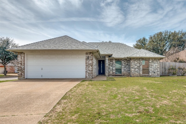 view of front of property featuring a garage, a front yard, concrete driveway, and roof with shingles