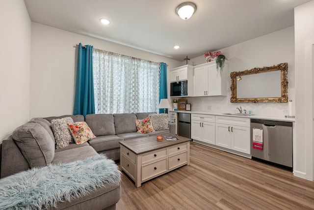 living room featuring light wood-style flooring and recessed lighting