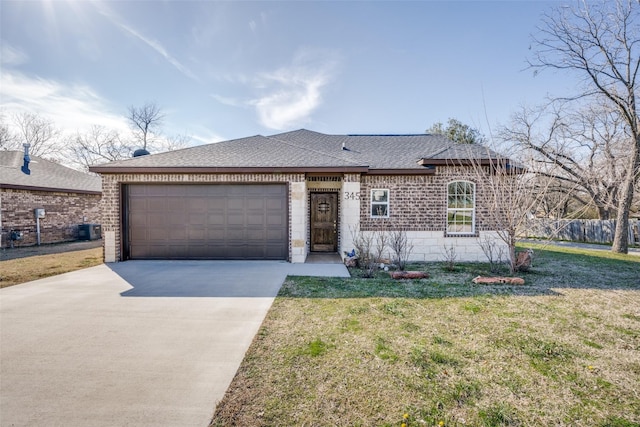 ranch-style home featuring a garage, concrete driveway, a shingled roof, and a front yard