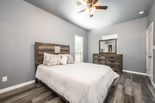 bedroom with dark wood-type flooring, visible vents, and baseboards