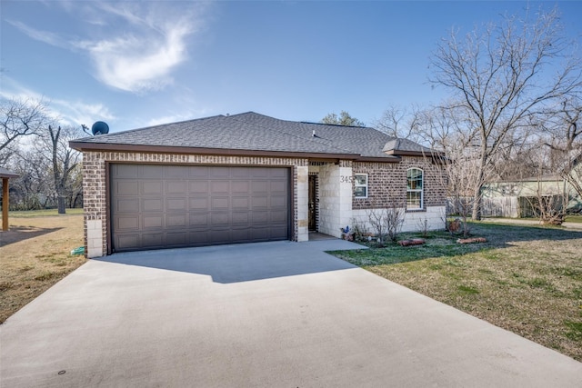 view of front of house with a garage, roof with shingles, concrete driveway, and a front yard