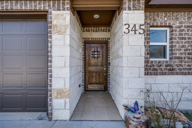 property entrance with stone siding and brick siding