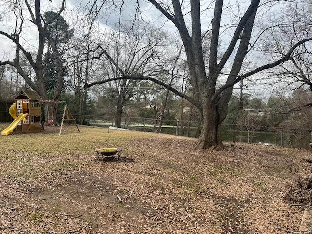 view of yard featuring fence and a playground