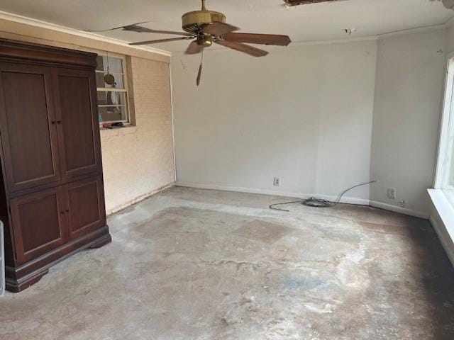 spare room with a ceiling fan and unfinished concrete flooring