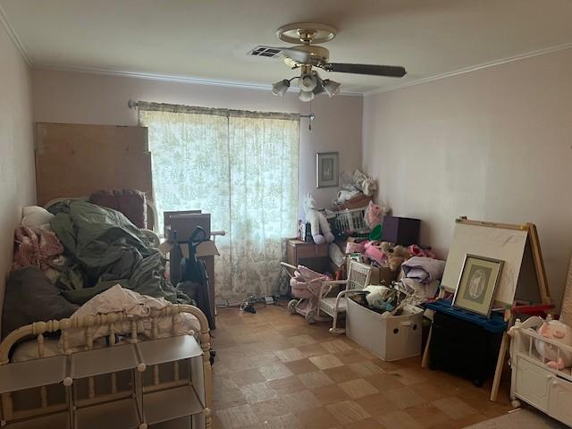 misc room with light floors, a ceiling fan, visible vents, and crown molding