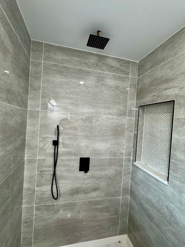 full bathroom with tiled shower