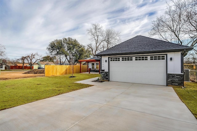 garage with concrete driveway, central AC, and fence