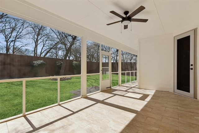 unfurnished sunroom with ceiling fan