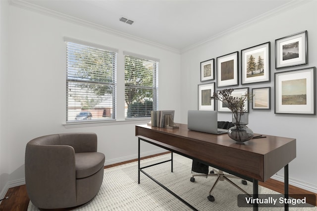 office featuring ornamental molding, wood finished floors, visible vents, and baseboards