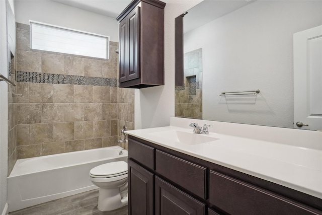 bathroom featuring vanity, bathing tub / shower combination, wood finished floors, and toilet