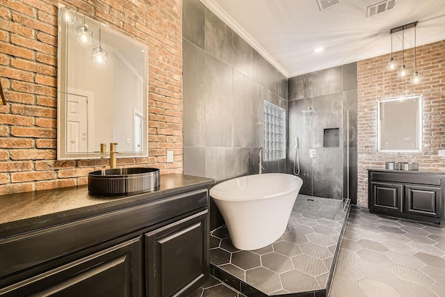 bathroom featuring visible vents, crown molding, vanity, a freestanding tub, and a walk in shower