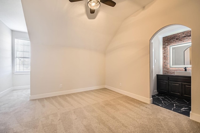 bonus room featuring lofted ceiling, carpet, baseboards, and a sink