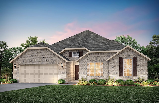 french country home with roof with shingles, driveway, an attached garage, and a lawn