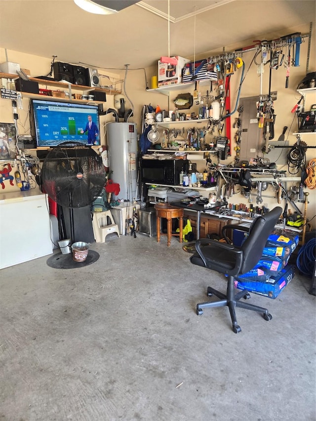 garage with gas water heater and a workshop area