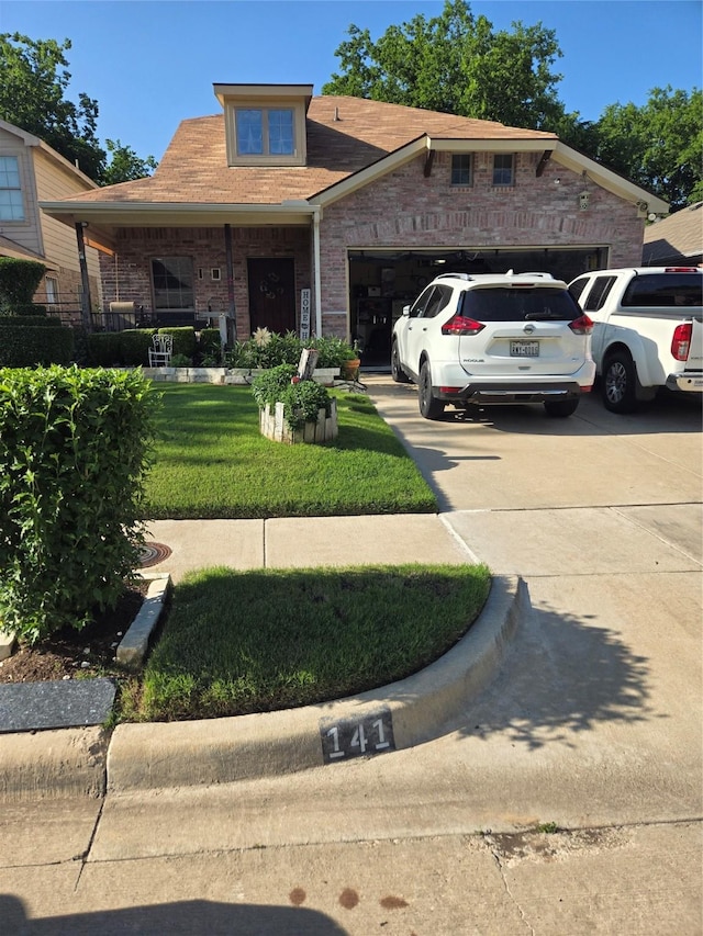 view of front of property featuring concrete driveway, brick siding, a front lawn, and an attached garage