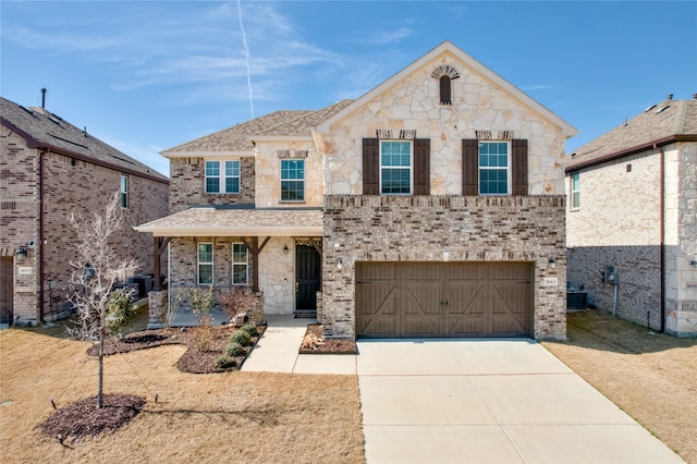 view of front of home featuring stone siding, brick siding, driveway, and an attached garage