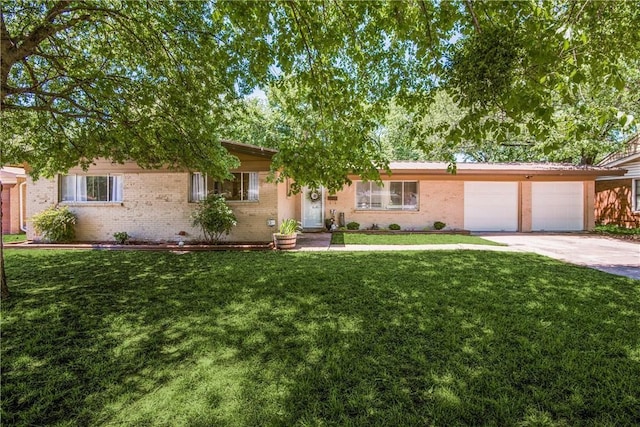 ranch-style home featuring driveway, brick siding, and a front yard