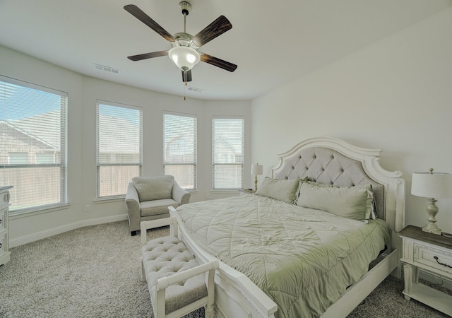 bedroom featuring carpet flooring, visible vents, baseboards, and multiple windows