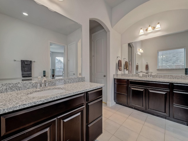 full bath with two vanities, a sink, and tile patterned floors