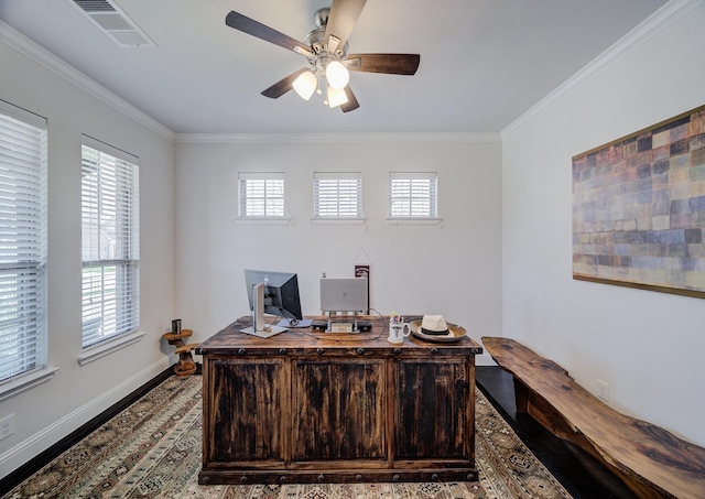 home office featuring ornamental molding, visible vents, baseboards, and a ceiling fan