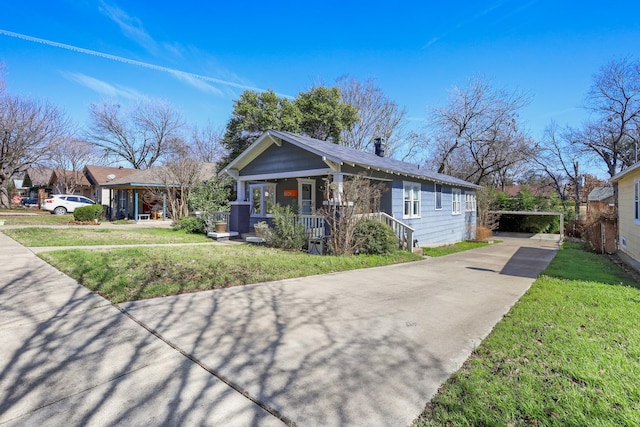 view of front of property with a porch, a front yard, and driveway