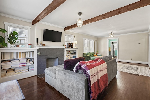 living area with dark wood-style floors, beamed ceiling, plenty of natural light, and a fireplace