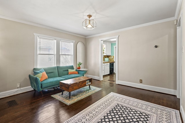 living area with dark wood-style floors, ornamental molding, visible vents, and baseboards