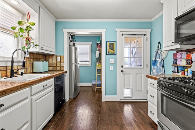 kitchen featuring a sink, white cabinets, black appliances, tasteful backsplash, and dark wood finished floors