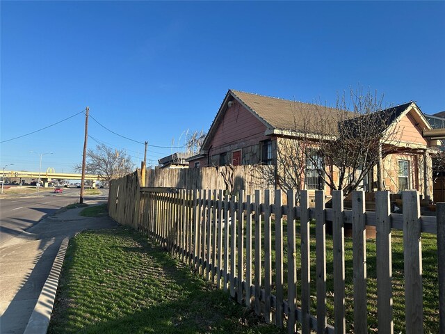 view of side of home with fence