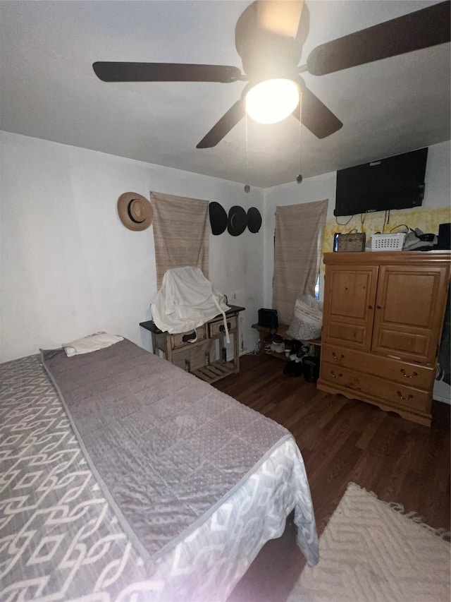 bedroom with ceiling fan and dark wood finished floors