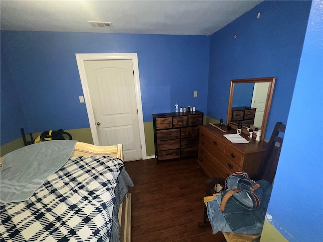 bedroom featuring dark wood-style floors and visible vents