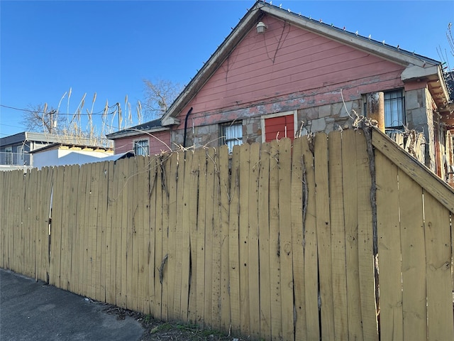 view of property exterior with fence