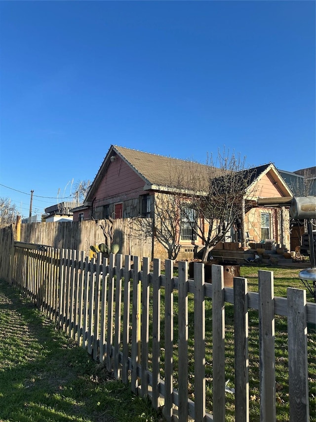 view of gate featuring a yard and fence