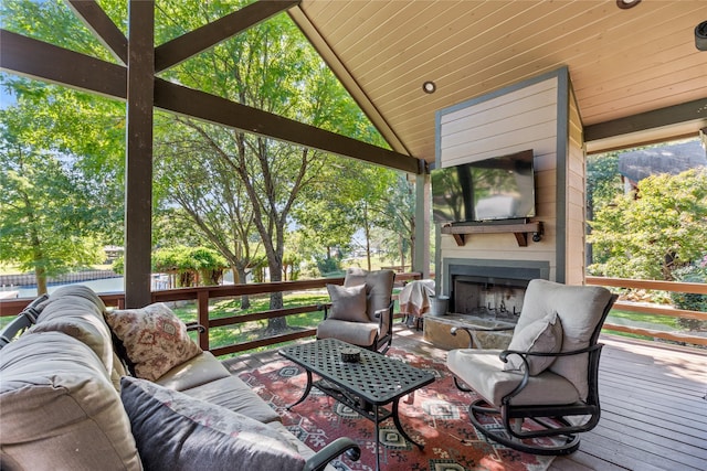 wooden deck with an outdoor living space with a fireplace