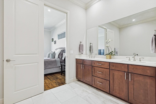 ensuite bathroom with ensuite bath, crown molding, and a sink