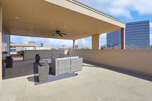 view of patio / terrace featuring a ceiling fan, an outdoor living space, and a city view