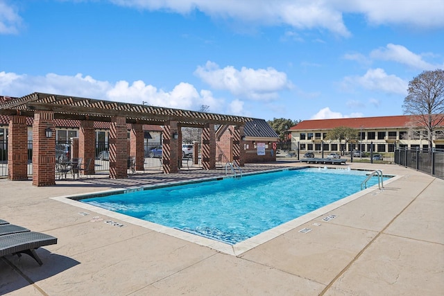 pool with a patio area, fence, and a pergola