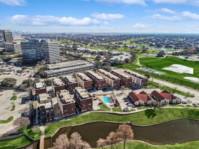 birds eye view of property featuring view of golf course, a water view, and a city view