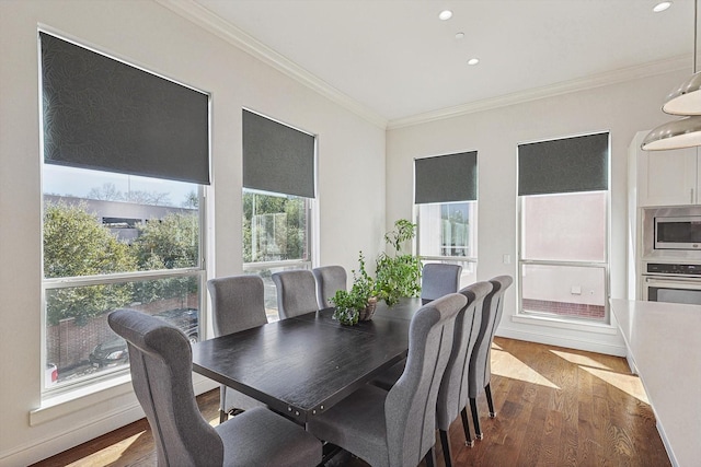 dining space with ornamental molding, recessed lighting, and dark wood finished floors