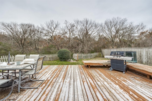 deck with outdoor dining area and a fenced backyard