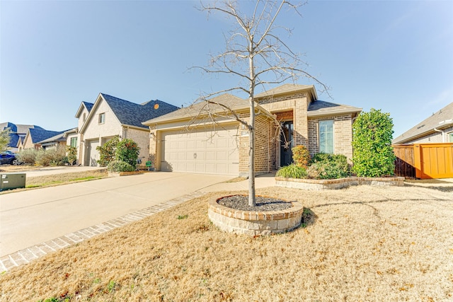 view of exterior entry with an attached garage, a shingled roof, concrete driveway, and brick siding