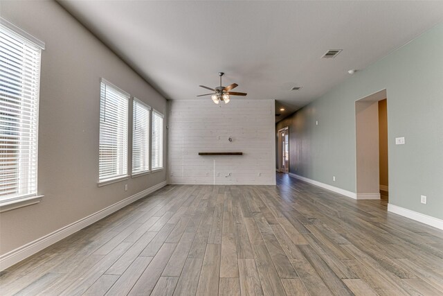 kitchen featuring a center island with sink, visible vents, appliances with stainless steel finishes, open floor plan, and a sink