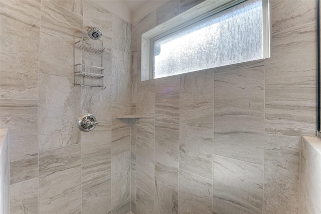 full bathroom featuring tiled shower