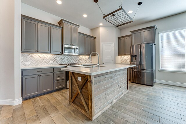 unfurnished living room with baseboards, ceiling fan, visible vents, and wood finished floors