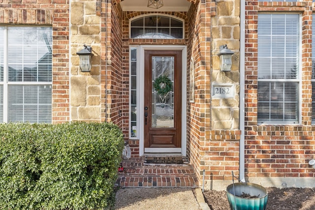 doorway to property with brick siding