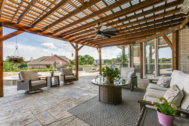 view of patio featuring a hot tub, a ceiling fan, an outdoor living space, and a pergola