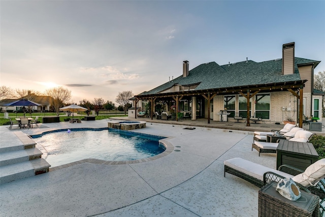 view of pool with a pool with connected hot tub and a patio