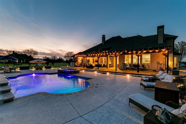 view of pool featuring a pool with connected hot tub, an outdoor living space, and a patio