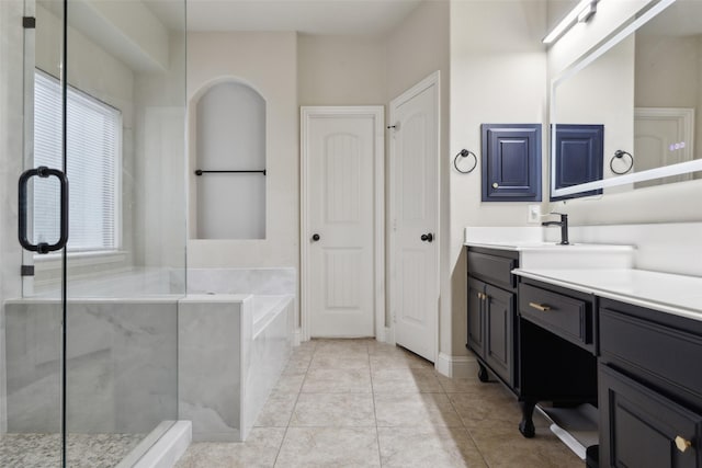 bathroom featuring a closet, a stall shower, vanity, tile patterned flooring, and a bath